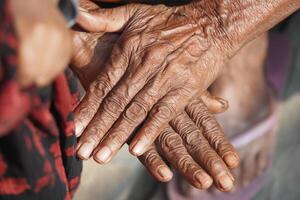 Elderly hands showing age and experience in a warm setting photo