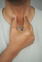 Checking pulse on neck in a calm setting indoors photo