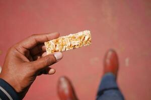 Snack time with a crunchy bar made of nuts photo