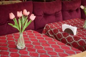 Elegant table setting with tulips and vibrant fabric photo