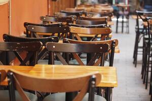 Chairs and tables arranged in a cozy outdoor cafe setting photo