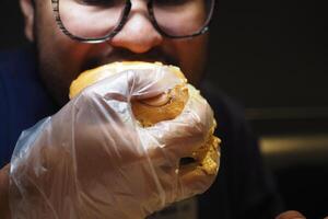 Enjoying a burger at a lively diner on a weekend night photo