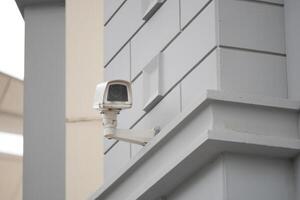 Security camera mounted on a modern building wall photo