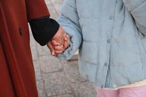 Holding hands on a chilly day in the city photo