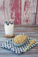soya beans and glass of milk on table photo