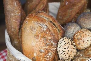 Freshly baked bread and rolls in a woven basket photo