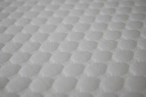Textured surface of a soft mattress cover in closeup view photo