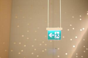 Exit sign directs to safety in bright space photo