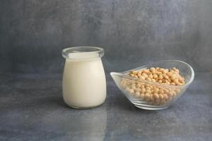 Fresh soy milk and soybeans displayed on a countertop photo