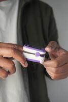 Using a fingertip device for health monitoring photo