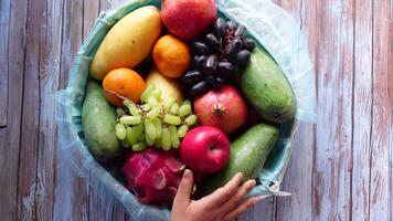 Fresh fruits arrangement in a colorful basket on wood video