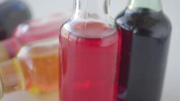 Colorful bottles filled with vibrant liquids on display video