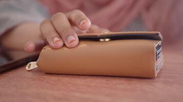 Wallet resting on a wooden table during a casual gathering video