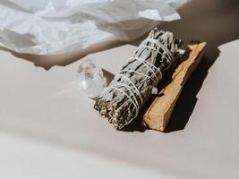 White sage and Palo Santo on a light beige background. A set of incense for fumigation photo