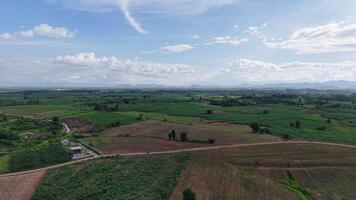 High-angle drone shot showing a narrow mountain road cutting through the landscape. The atmosphere is still and peaceful, just before rain begins to fall from the moody clouds. video