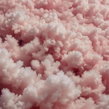There is a bunch of fluffy pink and white clouds floating in the sky photo