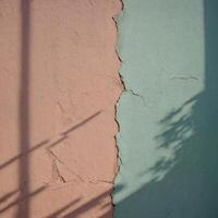 A beautifully painted wall in pink and green shades with a shadow cast upon it photo