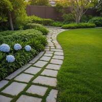 A stone walkway winds through a lush garden of vibrant plants photo