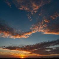 A beautiful sunset featuring many clouds scattered across the sky photo