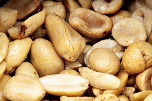 Close-up of salted roasted peanuts in macro view photo