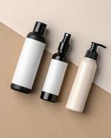 Three empty cosmetic bottles on a beige background photo