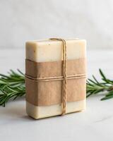 A soap bar wrapped in twine with a sprig of rosemary photo