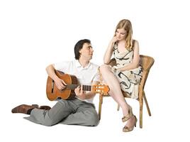 Man serenading to a girl, studio shot photo