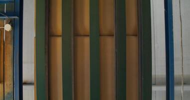 A paper factory. Corrugated cardboard moving on the machine, close up, top view photo