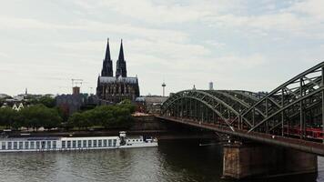 Railway bridge with train moving over it from a bird's eye view. Panoramic shooting from a drone, view of the historic center of Cologne, Germany. photo