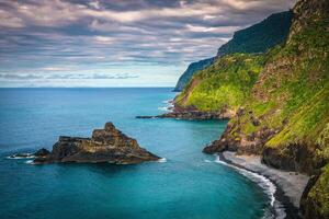 Amazing seaside view with colorful rocks and green steep slopes photo