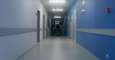 Medical staff and relatives of the victim are running down the hospital corridor carrying the patient on a gurney - victim photo