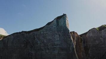 A person standing on top of a cliff photo