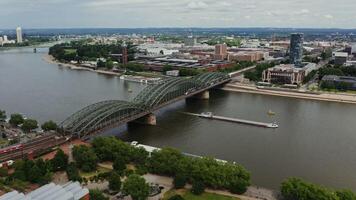 Large empty ferry floats under a bridge located in the historic center of Cologne. Wide river Rhine from a bird's eye view. Beautiful places in Germany, drone . photo