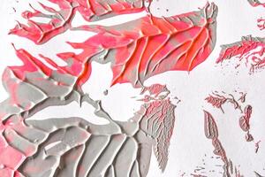 Abstract gray and pink textured paint strokes on canvas with dynamic patterns and overlapping layers. photo