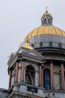 Views of St. Isaacs Cathedral With Its Iconic Golden Dome Against a Cloudy Sky in Saint Petersburg photo