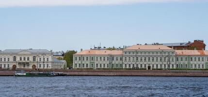 Historic Buildings Along the Neva River in St. Petersburg Showcasing Classic Architecture and Maritime Views Under a Clear Sky photo