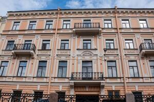 Historical Architecture Highlights in St Petersburg Featuring Decorative Balconies and Intricate Facades Under a Partly Cloudy Sky photo