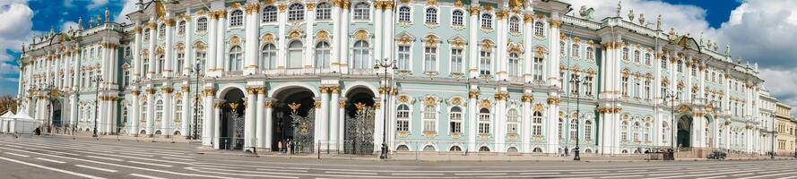 Spectacular View of the Winter Palace in St Petersburg Showcasing Its Colorful Architecture Under a Bright Sky photo