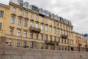Historic Building Along the Waterfront in St. Petersburg Showcasing Classic Architecture and Intricate Detailing Under a Cloudy Sky photo