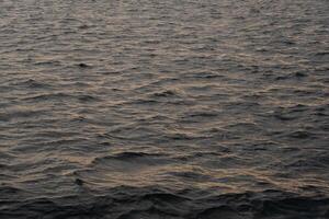 Bosphorus water at dusk reflecting soft light with gentle waves creating a serene atmosphere photo