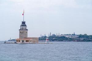 Bosphorus view featuring the famous Maidens Tower and historical skyline during a serene day photo