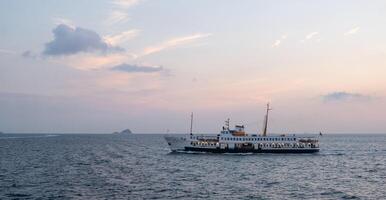 Bosphorus ferry sailing during sunset with a serene sky and calm waters photo