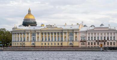 Historic Architecture Along the Waterfront in St. Petersburg Showcasing Domes and Beautiful Structures Under a Cloudy Sky photo