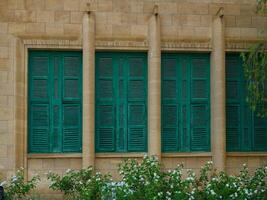 Old Stone Building with Green Shutters on Windows in Cyprus photo