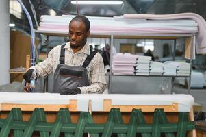 Furniture maker assembling sofa in factory photo