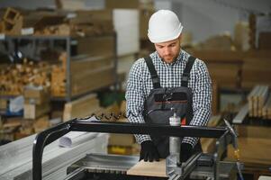 Carpenter using cnc machine in furniture factory for sofa production photo