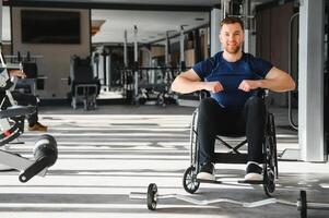 Man with disability, athlete smiling and training in a wheelchair at the gym photo