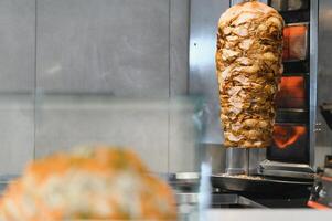 Shawarma rotating on a spit roasting in a fast food restaurant photo