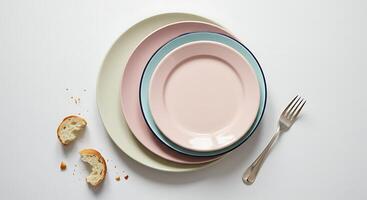 Stacked Plates with Bread and Fork on White Background photo