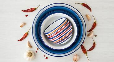 Arrangement of Kitchen Bowls with Garlic and Peppers on Table photo